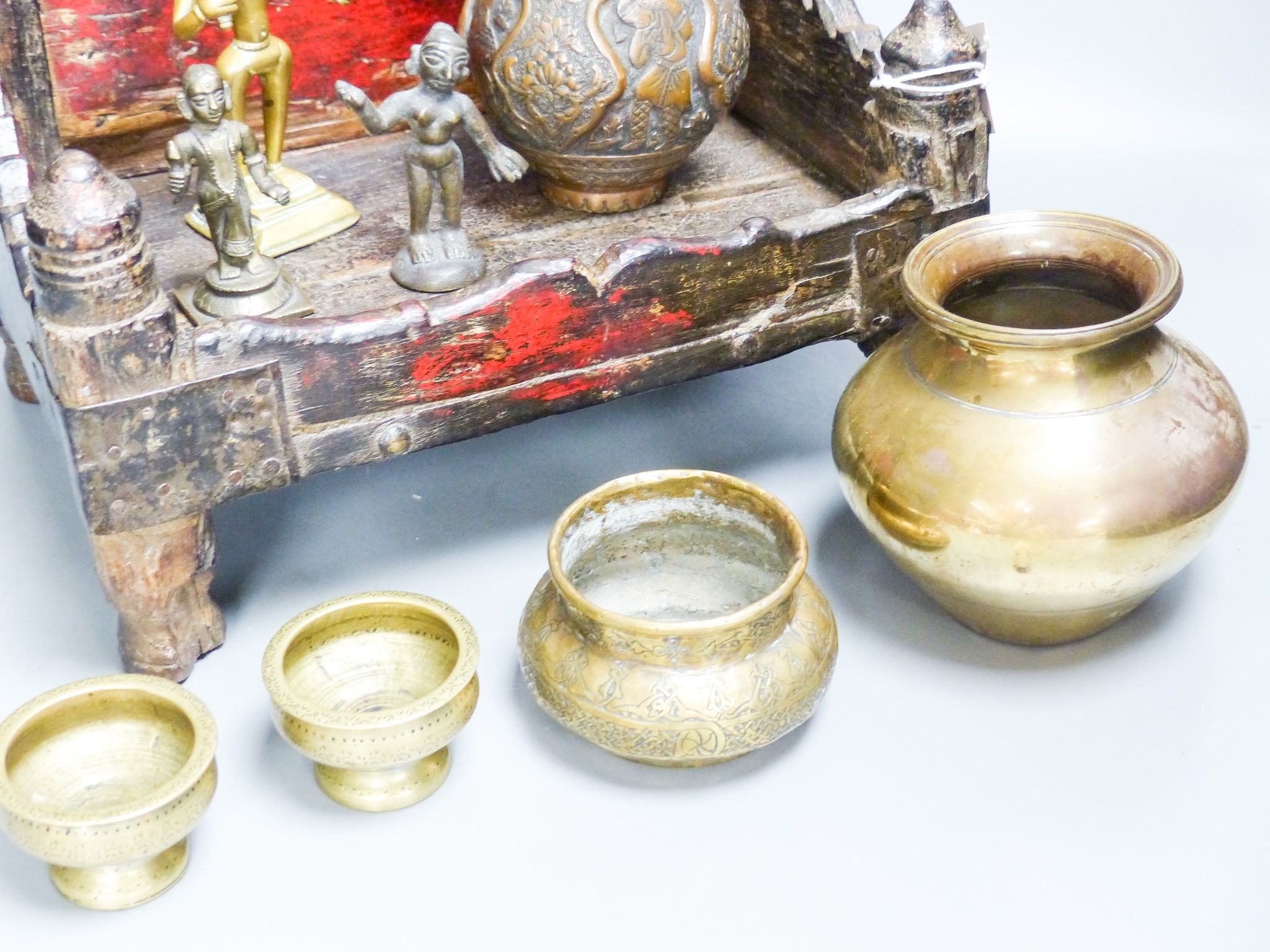 An Indian shrine stand, metalware figures and vessels (9), stand 29.5 cm wide